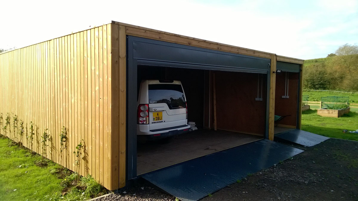 shipping container garage cladded with roller shutter